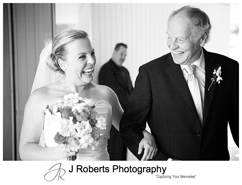 Bride and her father laughing as they walk down the aisle - sydney wedding photography 